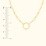 Gold chain necklace featuring a circular pendant with a small diamond.