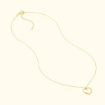 Delicate gold necklace with a heart-shaped pendant.