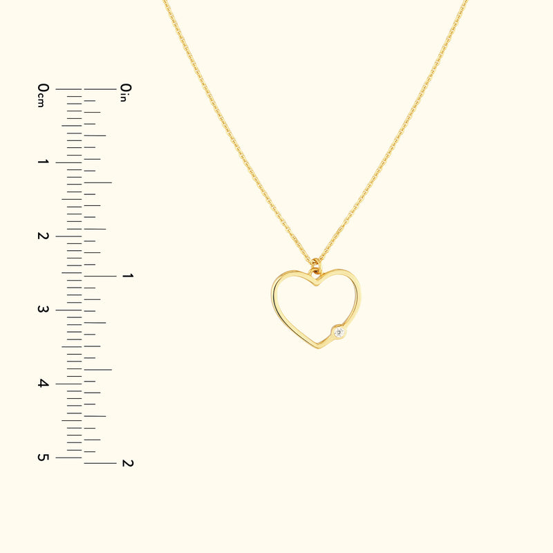 Golden heart-shaped necklace with a small diamond accent.
