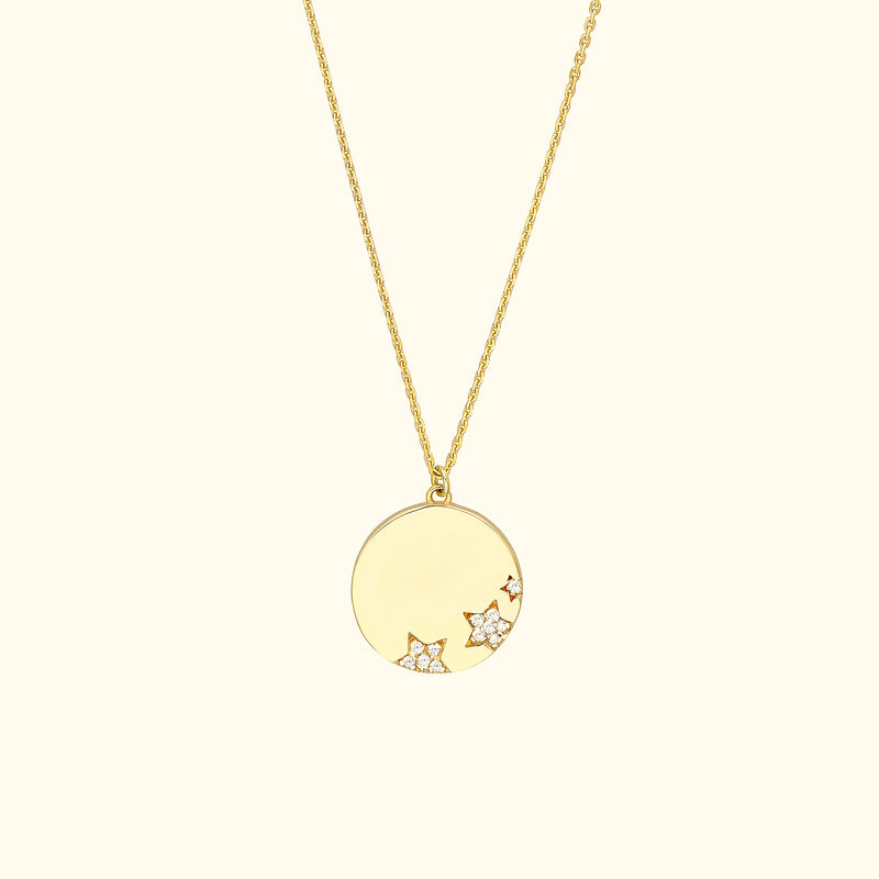 Gold pendant necklace with a smooth circular design and star-shaped diamond embellishments.