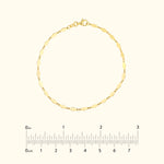 Delicate gold chain bracelet with hexagonal links and a clasp. Measurement scale included.