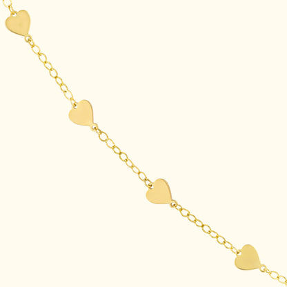 Gold chain bracelet featuring heart-shaped charms evenly spaced along the links.