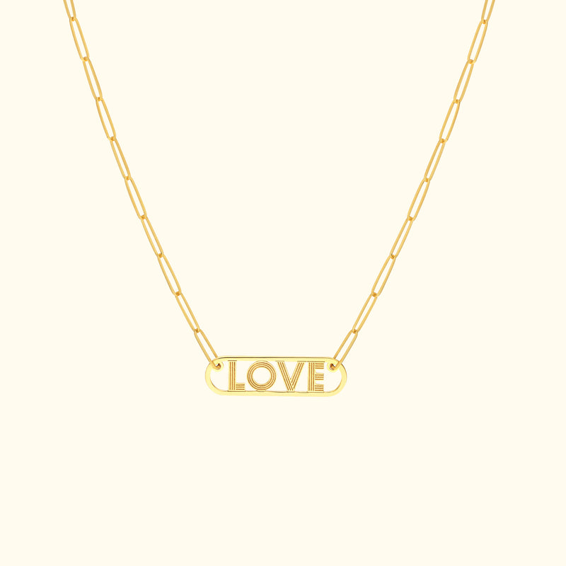 Gold necklace with a "LOVE" pendant on a delicate chain.