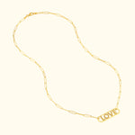 Gold necklace featuring the word "LOVE" in a pendant, linked with elongated chain.