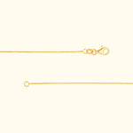Delicate gold necklace chain with a lobster clasp and a circular loop end.