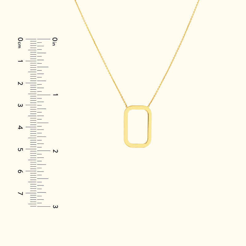 Gold rectangular pendant necklace on a delicate chain, displayed with a ruler for size reference.