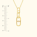Gold link pendant necklace featuring a small diamond, with a ruler for size reference.