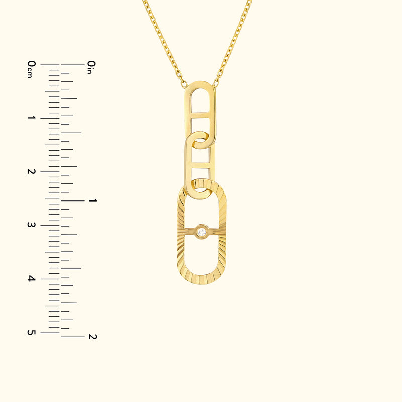 Gold link pendant necklace featuring a small diamond, with a ruler for size reference.