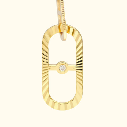 Gold rectangular pendant with a textured surface and a small diamond in the center.