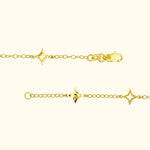 Delicate yellow gold chain bracelet with star-shaped charms and a lobster clasp.