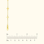 Gold chain necklace with star-shaped charms and a clasp, shown with a ruler for size reference.