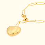 Gold necklace featuring a heart-shaped pendant with ribbed detailing.