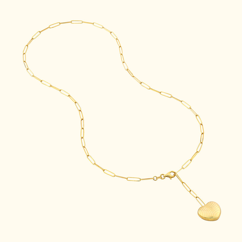 Gold chain necklace with a heart-shaped pendant, featuring elongated links.