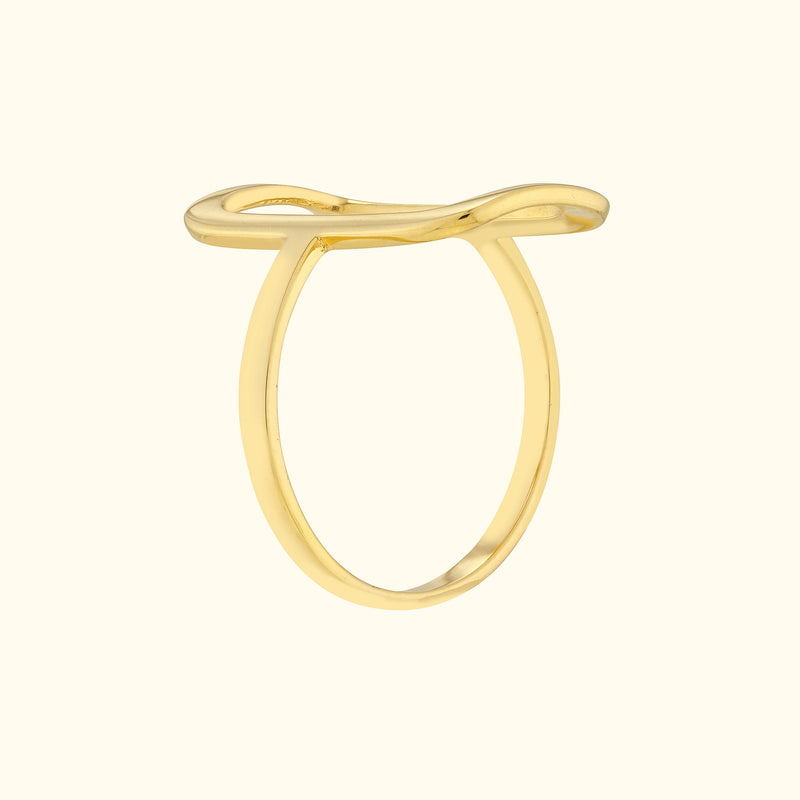 Minimalist gold ring with a smooth, wavy design.