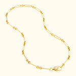 Gold chain necklace with oval links and a decorative clasp featuring a small diamond.
