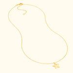 Delicate gold necklace featuring a small star pendant.