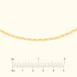Gold chain necklace displayed horizontally with a ruler for size reference.
