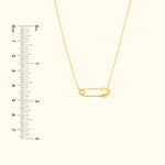 Gold safety pin necklace displayed next to a ruler for scale.