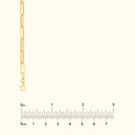 Gold chain bracelet with elongated links and a lobster clasp, displayed with a ruler.