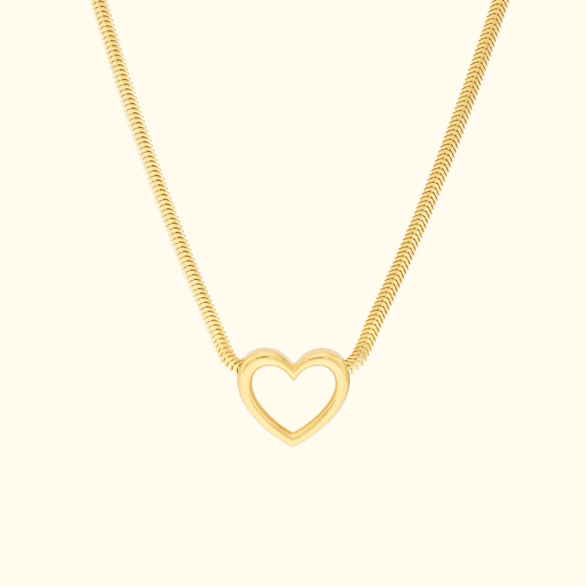 Gold necklace featuring a minimalist heart pendant on a sleek chain.