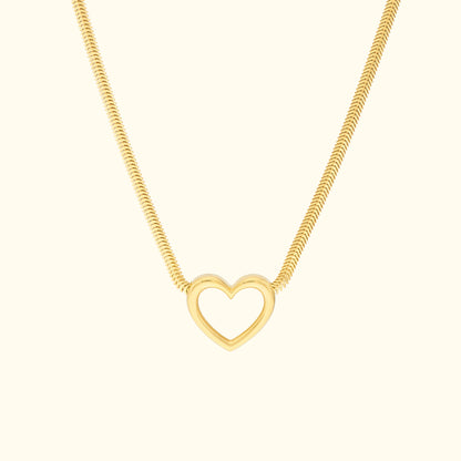 Gold necklace featuring a minimalist heart pendant on a sleek chain.