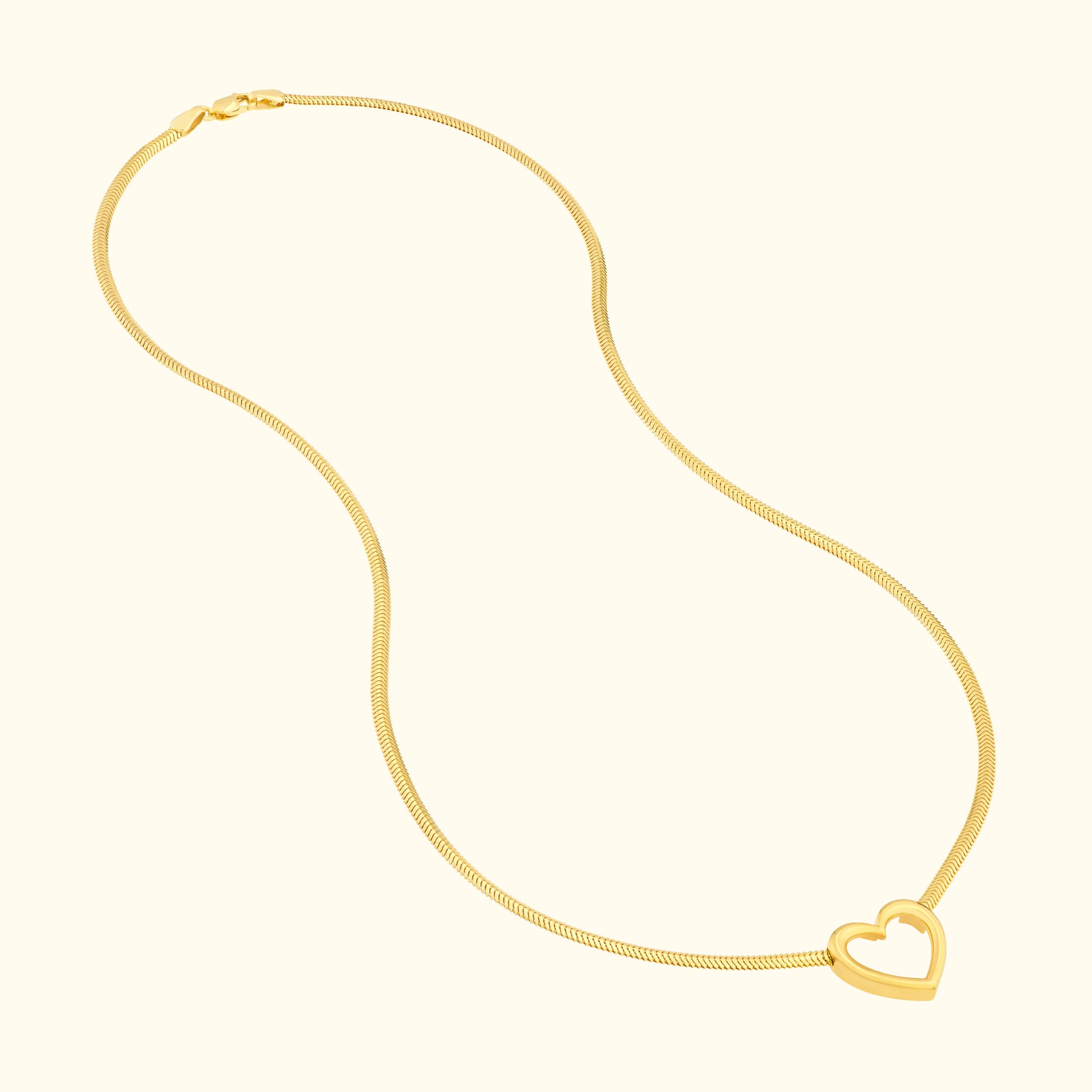 Glistening gold necklace featuring a heart-shaped pendant.