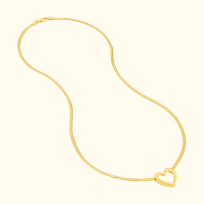 Glistening gold necklace featuring a heart-shaped pendant.