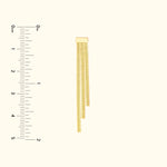 Gold chain with three dangling strands, displayed vertically beside a ruler for size reference.