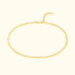 Gold chain bracelet with decorative zigzag and circular patterns.