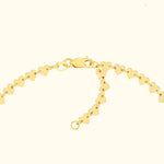 Gold heart-shaped charm bracelet with a secure clasp.