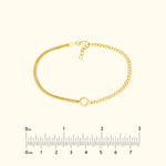Gold bracelet featuring a mix of textured and smooth chains, with a circular clasp.