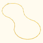 Gold chain necklace with rectangular links and decorative accents.