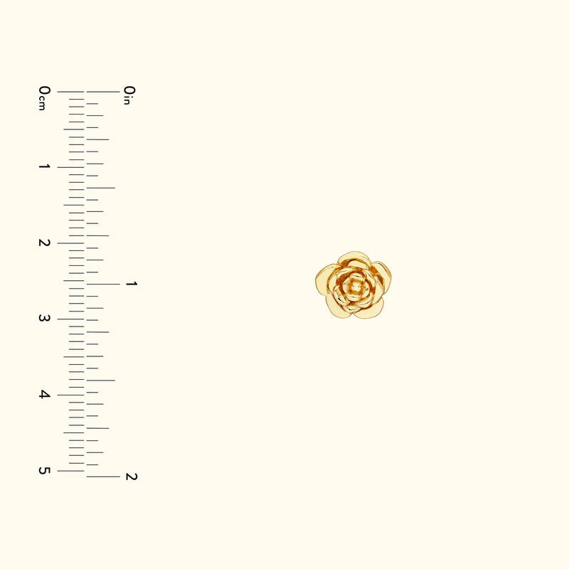 Delicate gold rose pin with layered petals on a light background, with a ruler for scale.