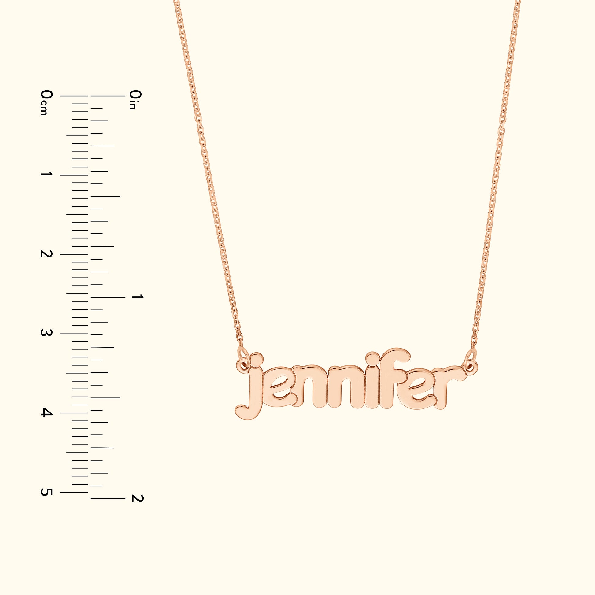 Rose gold necklace featuring the name "jennifer" in cursive font, against a light background.