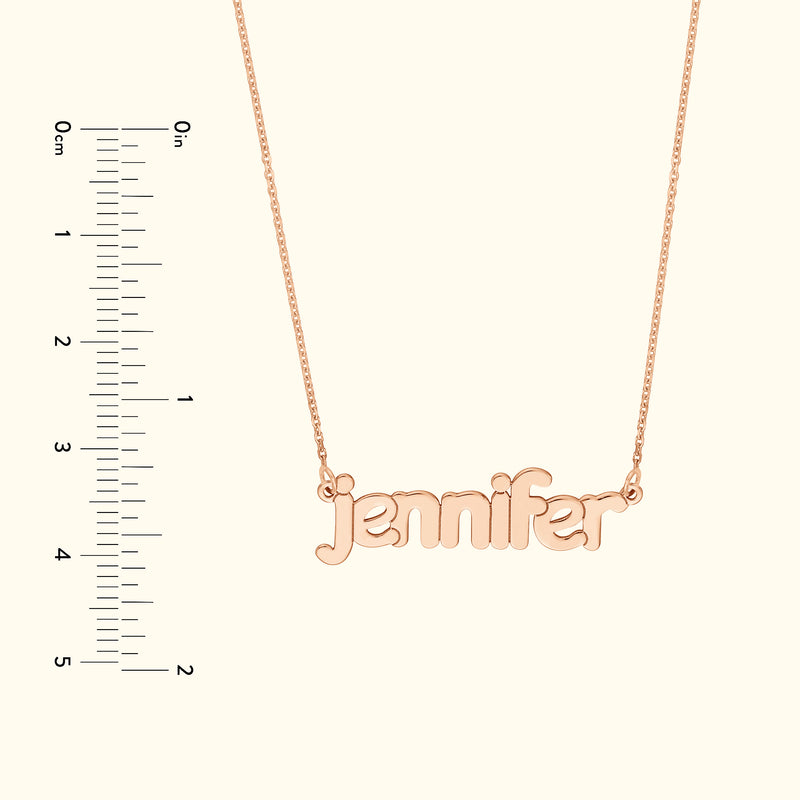 Rose gold necklace featuring the name "jennifer" in cursive font, against a light background.