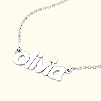 Silver name necklace with the name "Olivia" in a playful font.