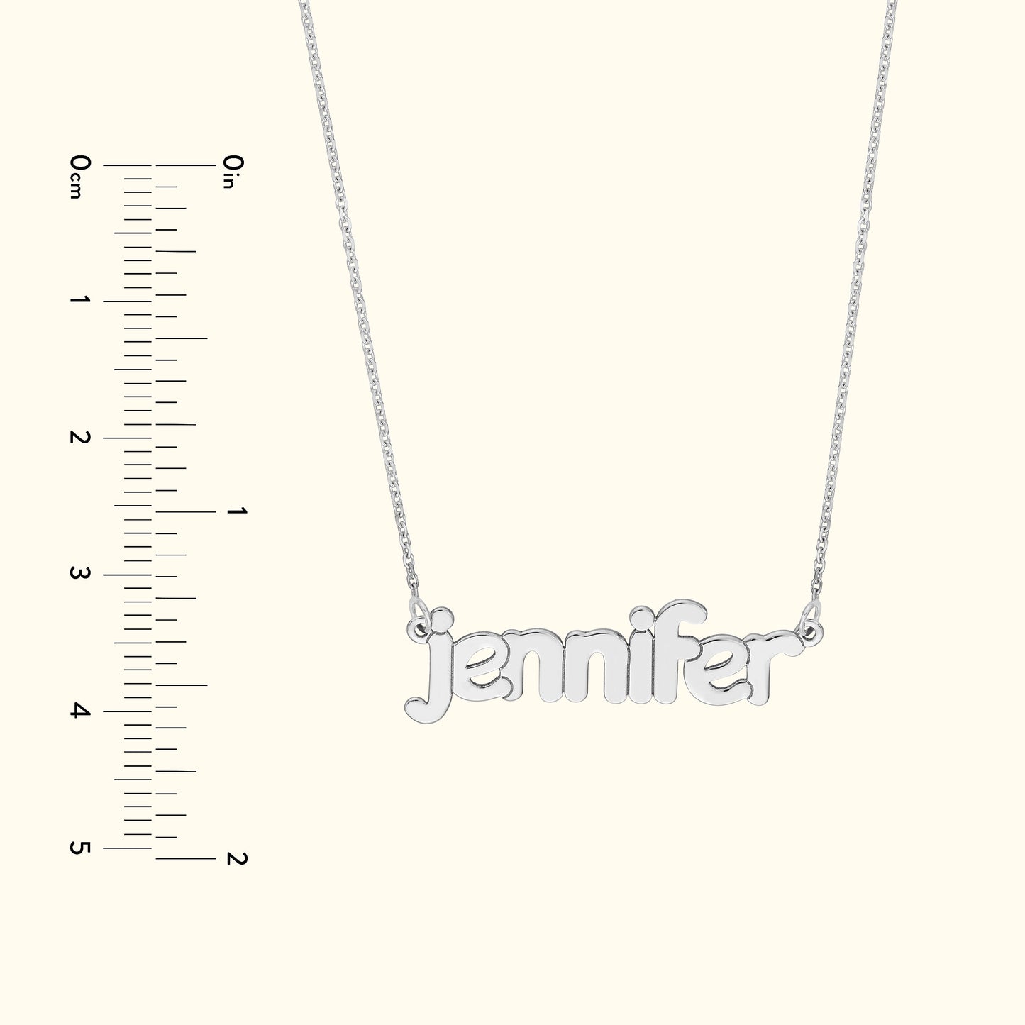 Silver name necklace spelling "jennifer" with a ruler for size reference.