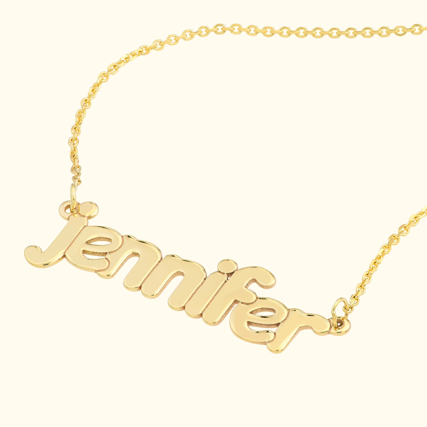 Gold name necklace with the word "jennifer" in a playful, cursive font.