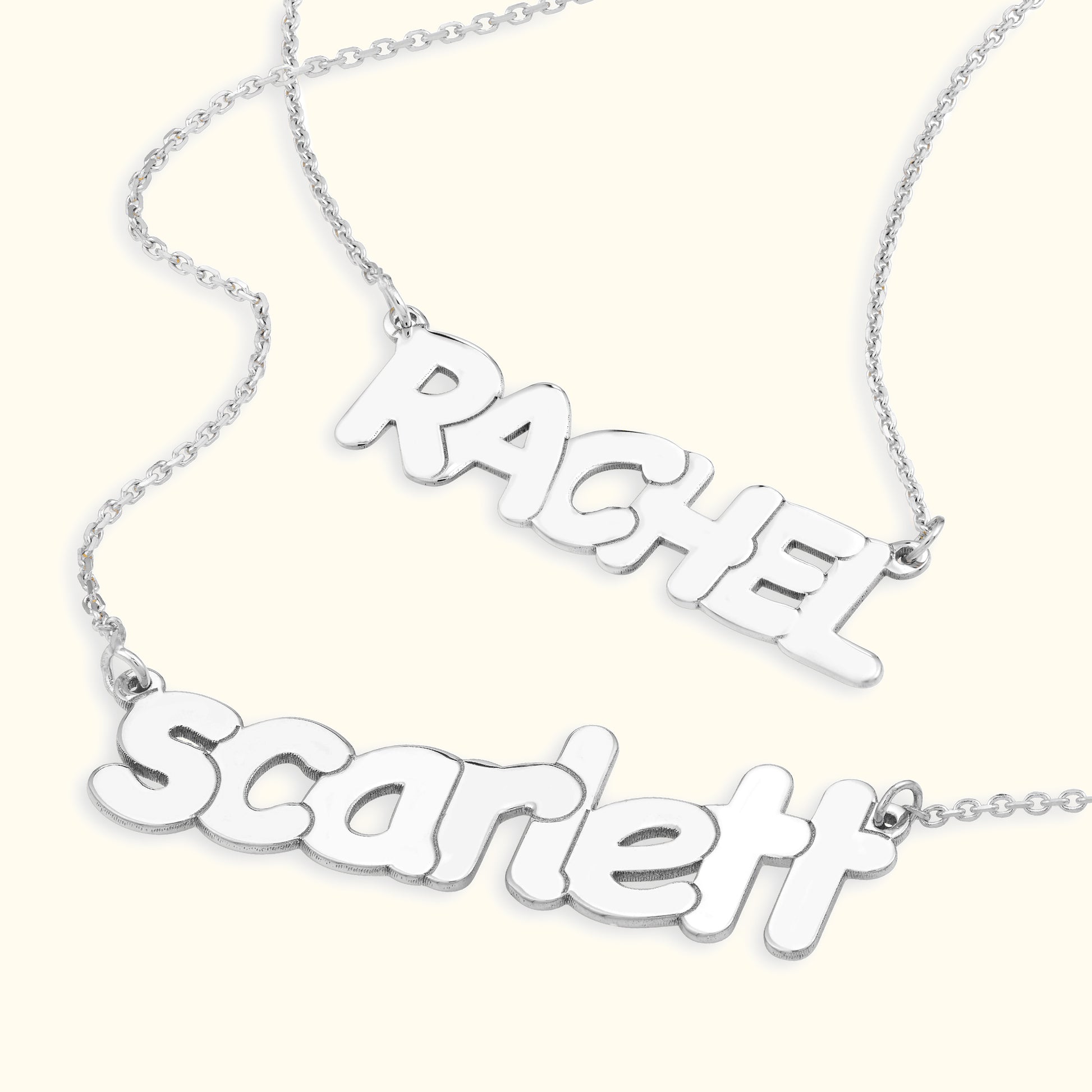 Silver name necklaces featuring the names "Rachel" and "Scarlett" in playful fonts.