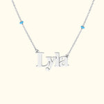 Silver necklace featuring the name "Lyla" with blue accents.