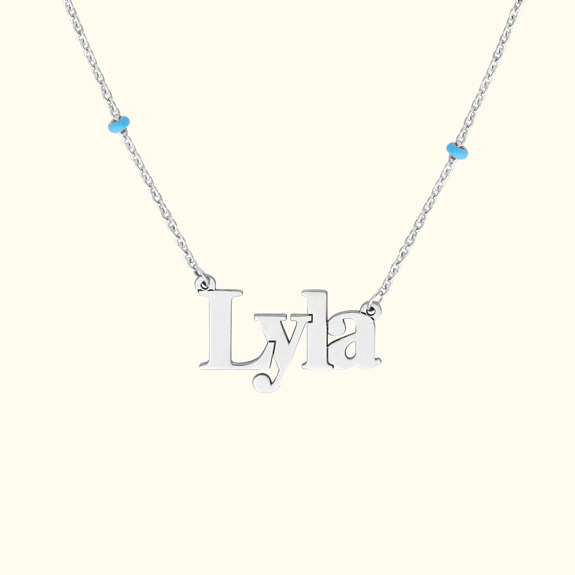 Silver necklace featuring the name "Lyla" with blue accents.