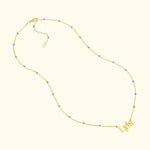 Gold necklace featuring the name "Lydia" with blue bead accents.