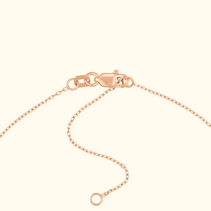 Rose gold necklace clasp with chain detail against a light background.