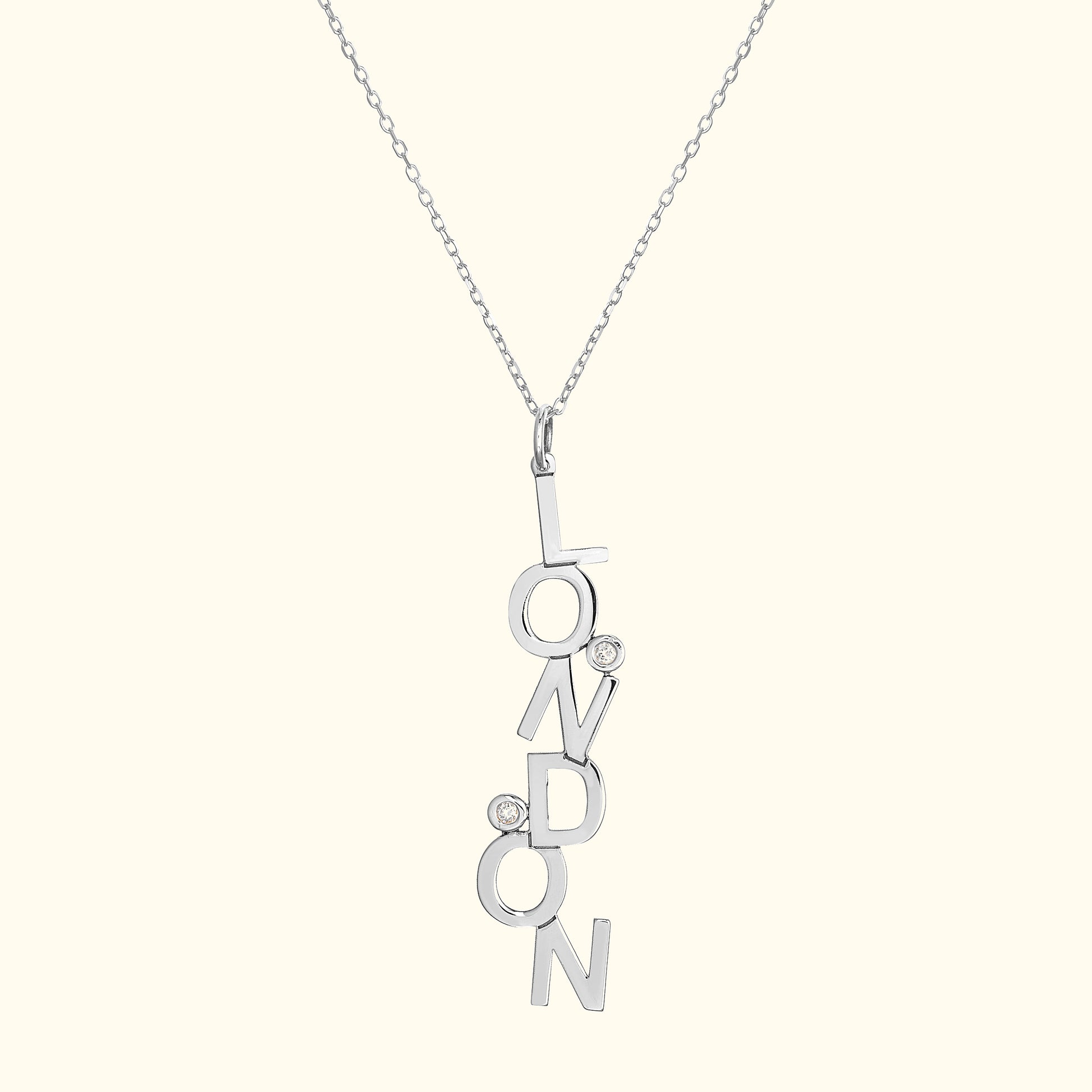 Silver necklace featuring "LONDON" in block letters with two small diamonds.