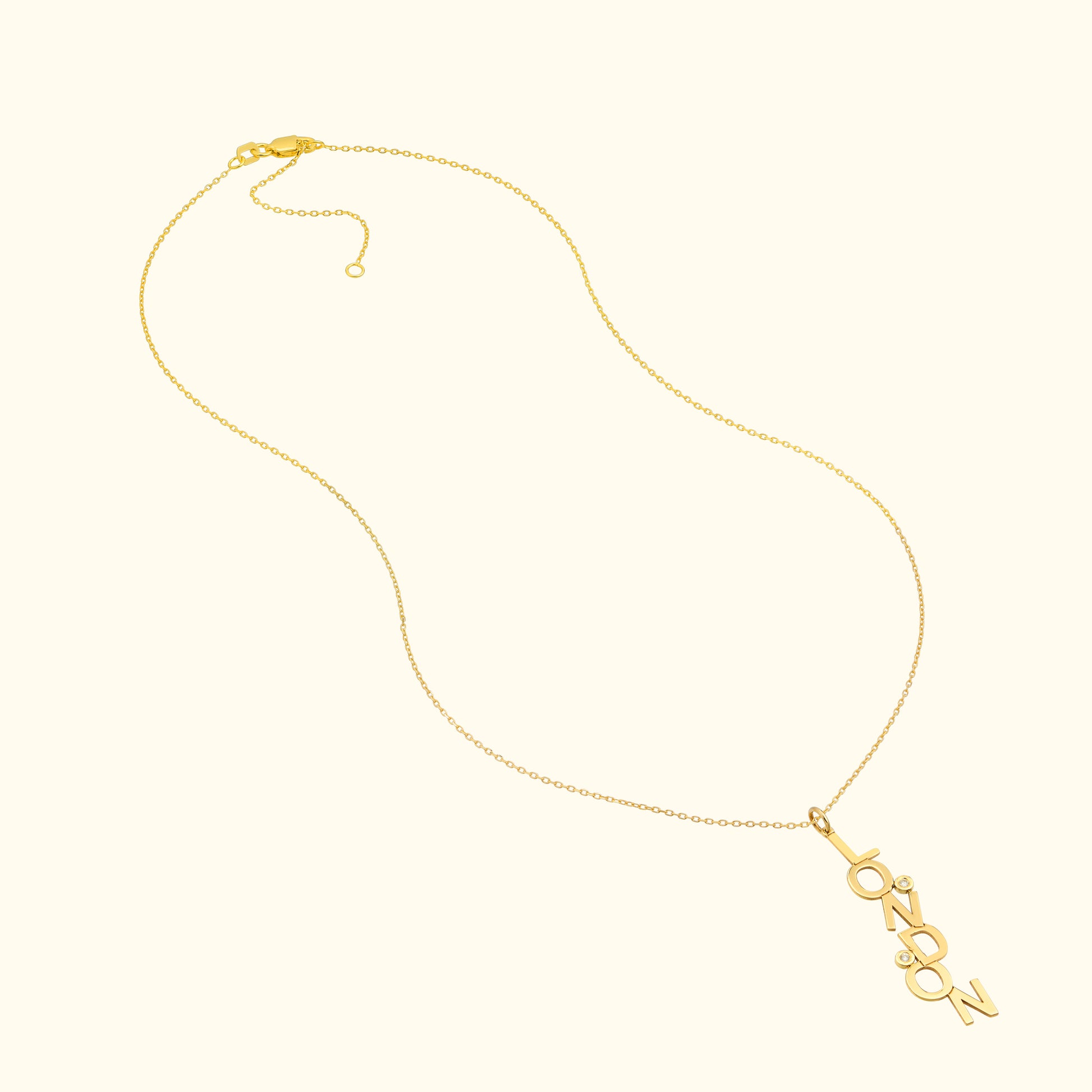 Gold necklace with the word "London" elegantly displayed as a pendant.