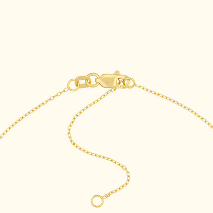 Close-up of a gold necklace clasp with a thin chain.