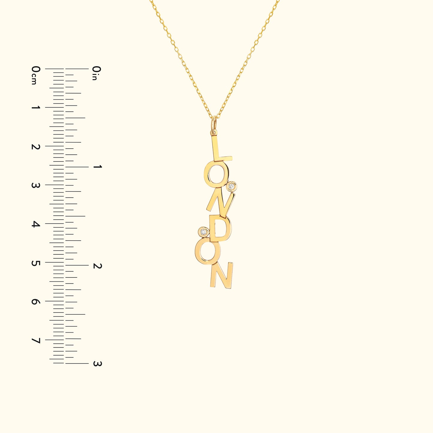 Gold necklace featuring "LONDON" letters with two small diamonds.