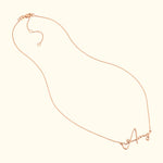 Delicate rose gold necklace featuring a cursive letter "A" pendant.