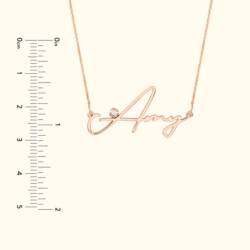 Rose gold name necklace featuring the name "Amy" with a small diamond accent.