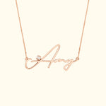 Rose gold necklace featuring a cursive name "Amy" with a small diamond accent.